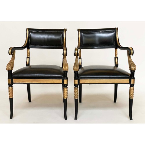 149 - ARMCHAIRS, a pair, Regency style lacquered and gilded with leather seats, scroll arms and swept supp... 