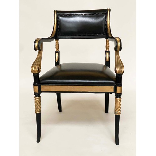 149 - ARMCHAIRS, a pair, Regency style lacquered and gilded with leather seats, scroll arms and swept supp... 