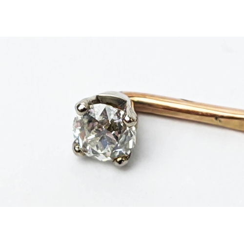 18 - A DIAMOND SET YELLOW HAT PIN, the brilliant cut stone of approximately 0.25 carat, plus a further pe... 