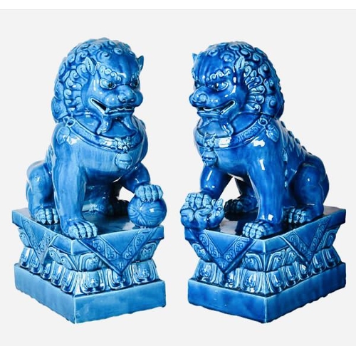 445 - FOO DOGS, a pair, 40cm high, 15cm wide, 25cm deep, cobalt blue glazed ceramic. (2)