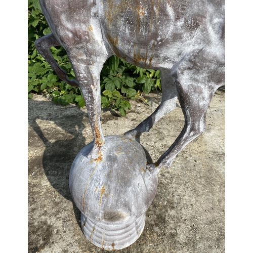 457 - SCULPTURAL STAGS, a pair, 100cm high, 60cm wide, cast metal, on globular bases. (2)