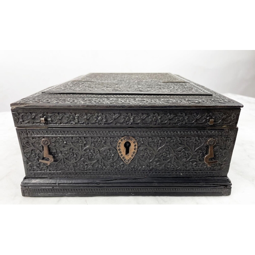 6 - JEWELLERY BOX, 19th century Anglo-Indian ornately carved ebony with hinged lid and fitted interior, ... 