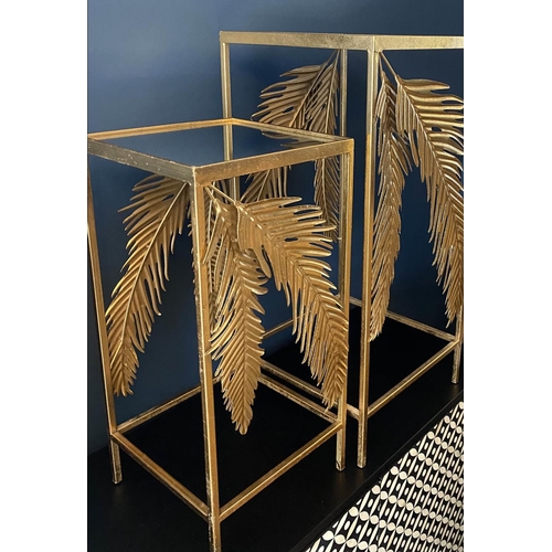 384 - SIDE TABLES, a graduated pair, 1970's Italian style, palm leaf detail, gilt metal, mirrored tops, la... 