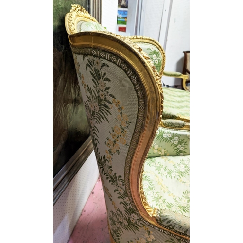 153 - LOUIS XVI STYLE BERGERE A OREILLE, 19th century gesso applied giltwood frame, green silk floral patt... 