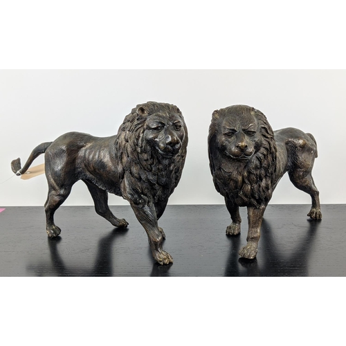 474 - CONTEMPORARY SCHOOL SCULPTURAL LIONS, a pair, cast metal, 45cm x 10cm x 25cm each. (2)