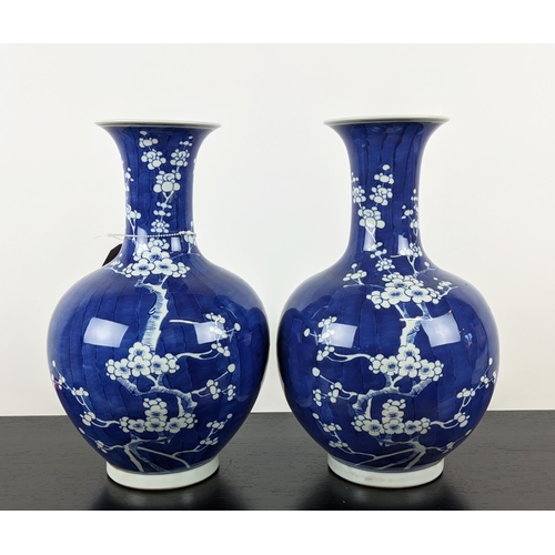 475 - VASES, a pair, 37cm H blue and white glazed ceramic with prunus decoration. (2)