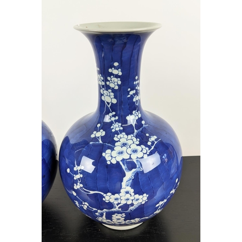 475 - VASES, a pair, 37cm H blue and white glazed ceramic with prunus decoration. (2)