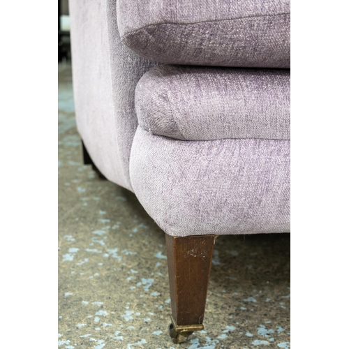 491 - HOWARD STYLE SOFA, 87cm H x 218cm W x 107cm D, in Designers Guild lilac chenille on brass castors.