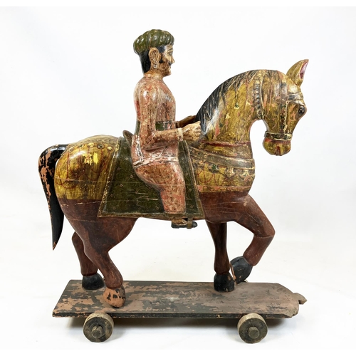 15 - MUGHAL SCHOOL,RAJASTHAN, INDIA 'Horse and rider', polychrome painted carved wood, 109cm H.