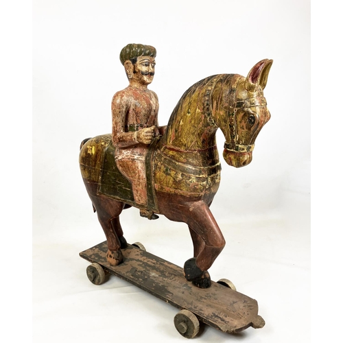 15 - MUGHAL SCHOOL,RAJASTHAN, INDIA 'Horse and rider', polychrome painted carved wood, 109cm H.