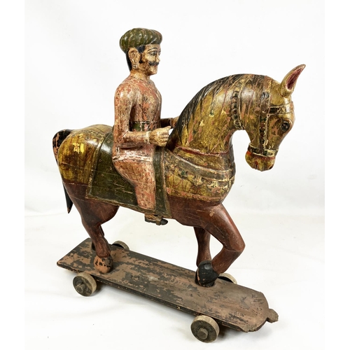 15 - MUGHAL SCHOOL,RAJASTHAN, INDIA 'Horse and rider', polychrome painted carved wood, 109cm H.