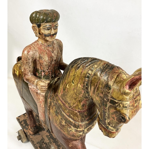 15 - MUGHAL SCHOOL,RAJASTHAN, INDIA 'Horse and rider', polychrome painted carved wood, 109cm H.