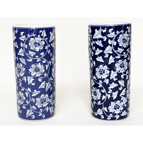 117 - STICK STANDS, a pair, Chinese blue and white ceramic, cylindrical with indigo blue ground, 45cm. (2)