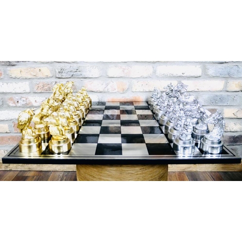 489 - CHESS SET, with silvered and gilt finish animal form pieces, 60cm x 60cm.