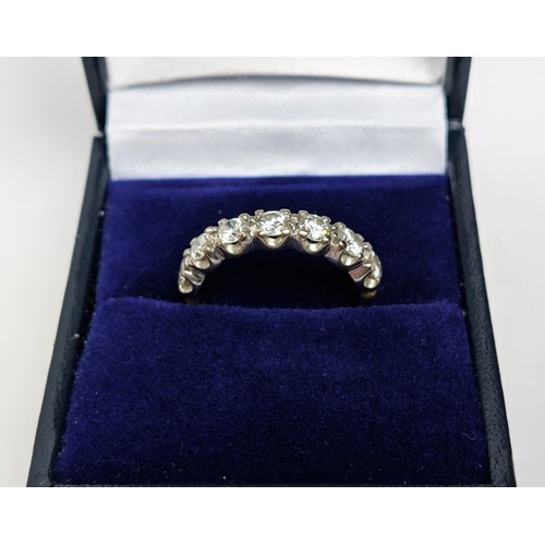 22 - AN 18CT GOLD DIAMOND HALF ETERNITY RING, set with seven round brilliant cut diamonds, claw set in a ... 
