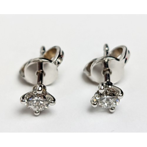 48 - A PAIR OF 18CT WHITE GOLD DIAMOND SOLITAIRE STUD EARRINGS, the round brilliant cut stones of a total... 