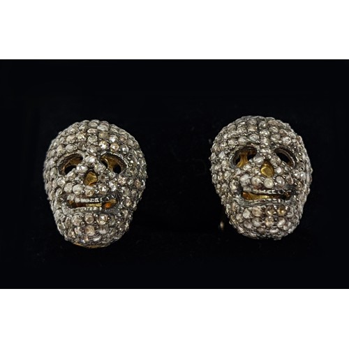 49 - A PAIR OF SILVER-GILT MEMENTO MORI-STYLE SKULL CUFFLINKS, with pave set rose cut diamonds, approxima... 