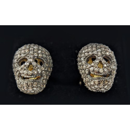 49 - A PAIR OF SILVER-GILT MEMENTO MORI-STYLE SKULL CUFFLINKS, with pave set rose cut diamonds, approxima... 