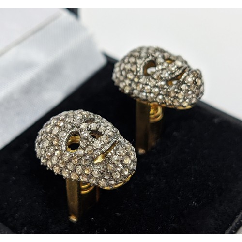 49 - A PAIR OF SILVER-GILT MEMENTO MORI-STYLE SKULL CUFFLINKS, with pave set rose cut diamonds, approxima... 