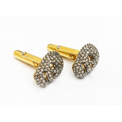 49 - A PAIR OF SILVER-GILT MEMENTO MORI-STYLE SKULL CUFFLINKS, with pave set rose cut diamonds, approxima... 