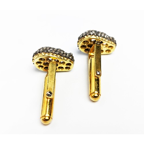 49 - A PAIR OF SILVER-GILT MEMENTO MORI-STYLE SKULL CUFFLINKS, with pave set rose cut diamonds, approxima... 