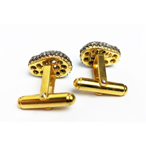 49 - A PAIR OF SILVER-GILT MEMENTO MORI-STYLE SKULL CUFFLINKS, with pave set rose cut diamonds, approxima... 