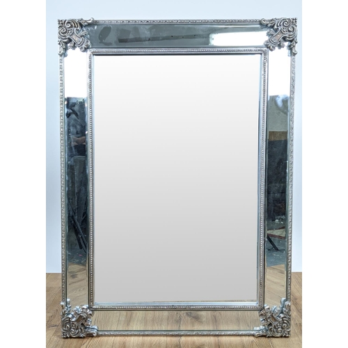 405 - WALL MIRROR, Continental style, mirrored frame with silvered detail, 114.5cm x 83cm.