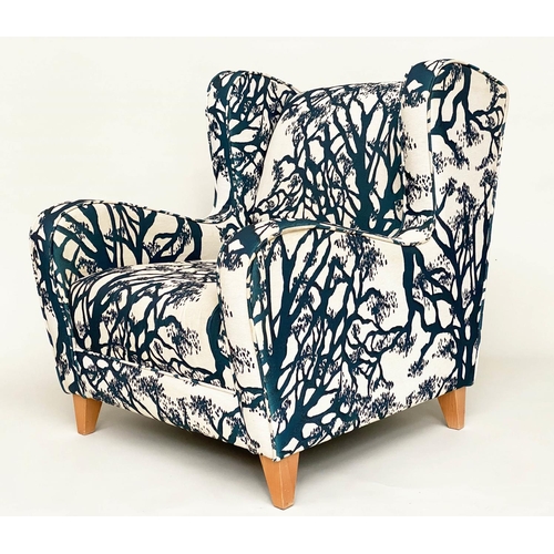 475 - WINGBACK ARMCHAIR, blue and cream 'tree' print upholstery, with tapering beech supports, 77cm W.