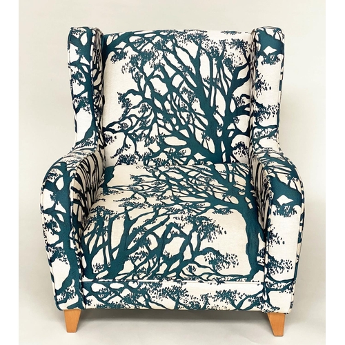 475 - WINGBACK ARMCHAIR, blue and cream 'tree' print upholstery, with tapering beech supports, 77cm W.