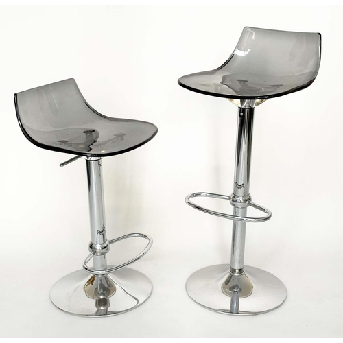 293 - BAR STOOLS, a pair, contemporary each with shaped lucite seat raised on pump action, chromium revolv... 