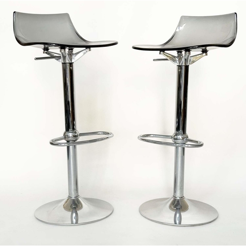 293 - BAR STOOLS, a pair, contemporary each with shaped lucite seat raised on pump action, chromium revolv... 