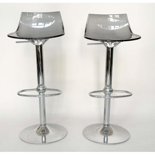 293 - BAR STOOLS, a pair, contemporary each with shaped lucite seat raised on pump action, chromium revolv... 