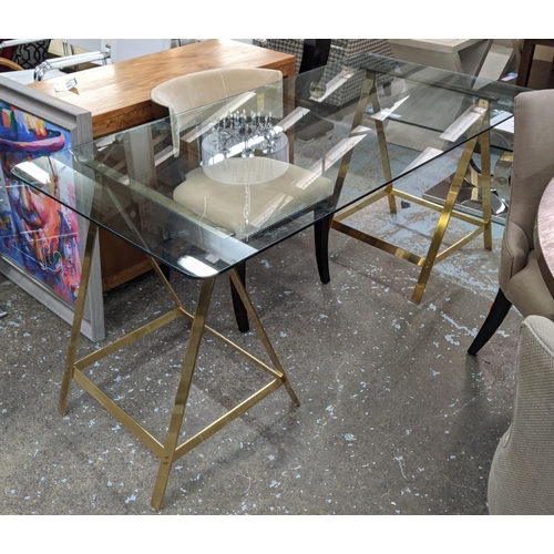 313 - TRESTLE DESK, 167cm x 84cm x 79cm, the glass top on gilt metal trestles.