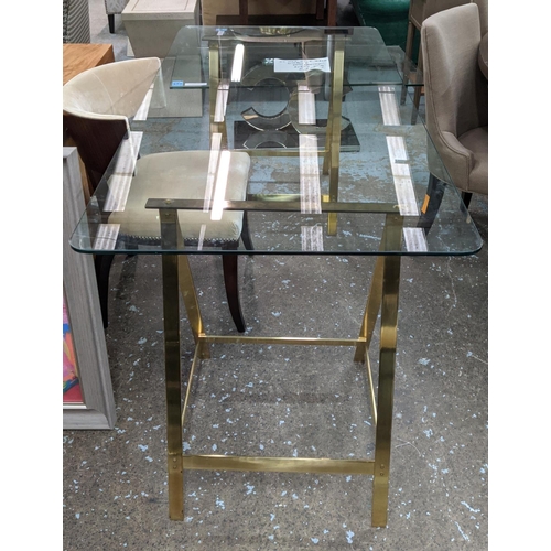 313 - TRESTLE DESK, 167cm x 84cm x 79cm, the glass top on gilt metal trestles.