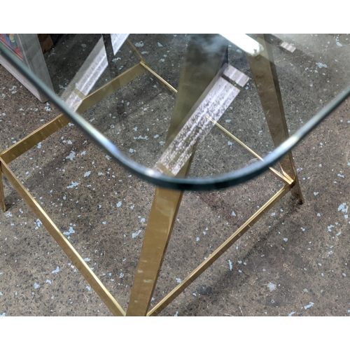 313 - TRESTLE DESK, 167cm x 84cm x 79cm, the glass top on gilt metal trestles.