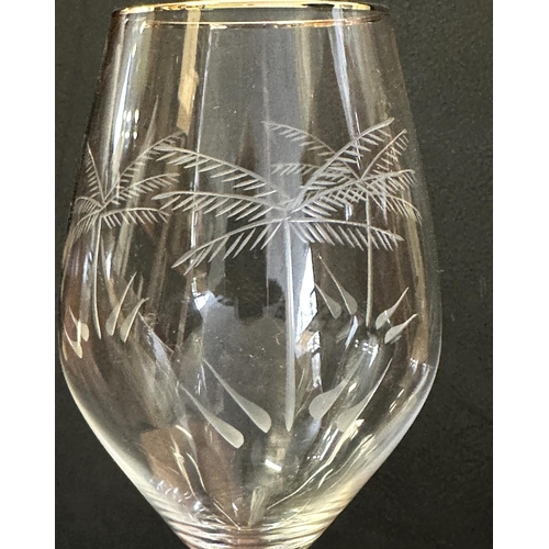 166 - PALM TREE DRINKING GLASSES, a set of twelve tall palm tree etched with gilded rim, 26cm H. (12)