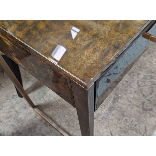 457 - VANITY TABLE, 120cm x 50cm x 75.5cm, tortoise shell effect glass, two drawers, gilt metal supports.