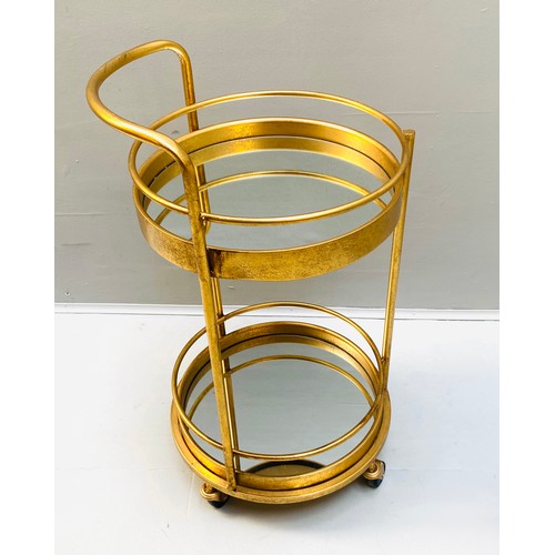 448 - COCKTAIL TROLLEY, 77cm high, 42cm diameter, 1960s French style, mirrored glass tiers, gilt metal fra... 