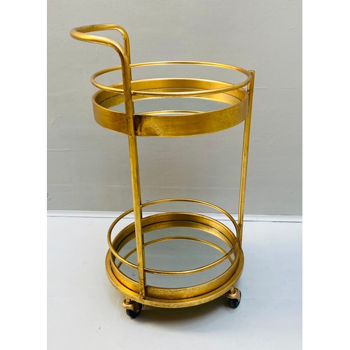 448 - COCKTAIL TROLLEY, 77cm high, 42cm diameter, 1960s French style, mirrored glass tiers, gilt metal fra... 