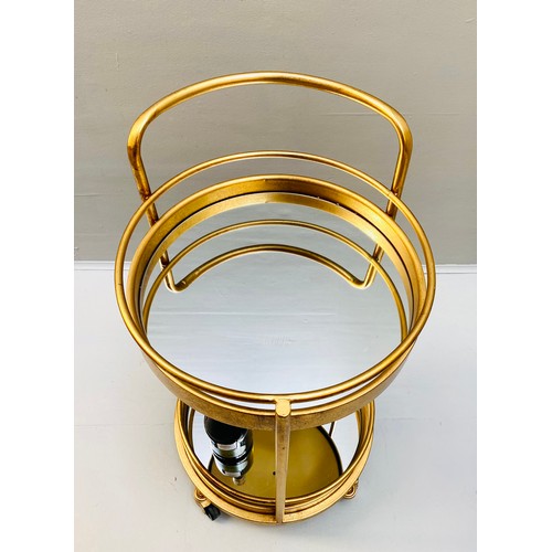 448 - COCKTAIL TROLLEY, 77cm high, 42cm diameter, 1960s French style, mirrored glass tiers, gilt metal fra... 