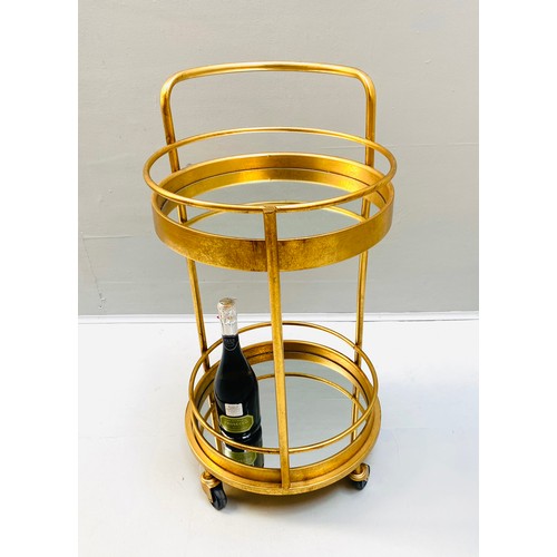 448 - COCKTAIL TROLLEY, 77cm high, 42cm diameter, 1960s French style, mirrored glass tiers, gilt metal fra... 