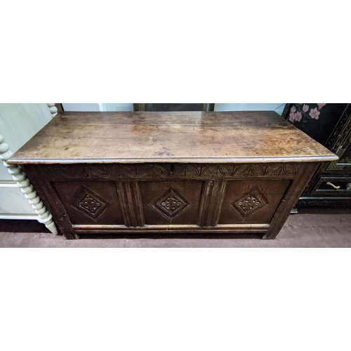 115 - COFFER, 132cm W x 46cm D x 58cm H, Charles II oak with a rising lid and three carved front panels.