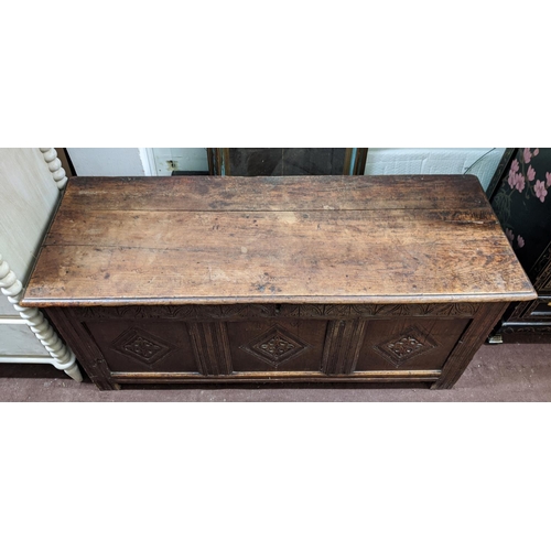 115 - COFFER, 132cm W x 46cm D x 58cm H, Charles II oak with a rising lid and three carved front panels.