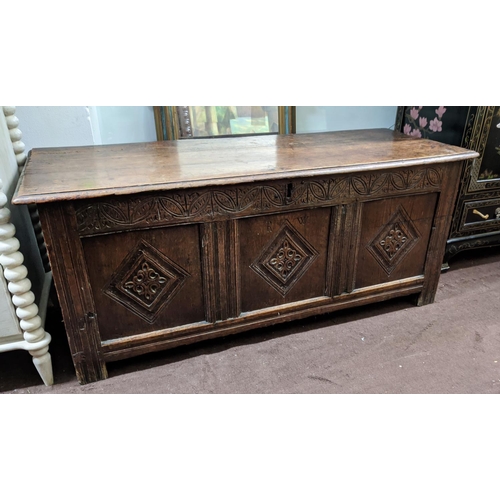 115 - COFFER, 132cm W x 46cm D x 58cm H, Charles II oak with a rising lid and three carved front panels.