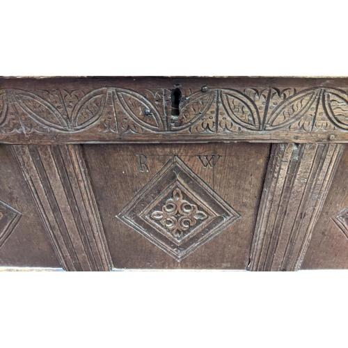 115 - COFFER, 132cm W x 46cm D x 58cm H, Charles II oak with a rising lid and three carved front panels.