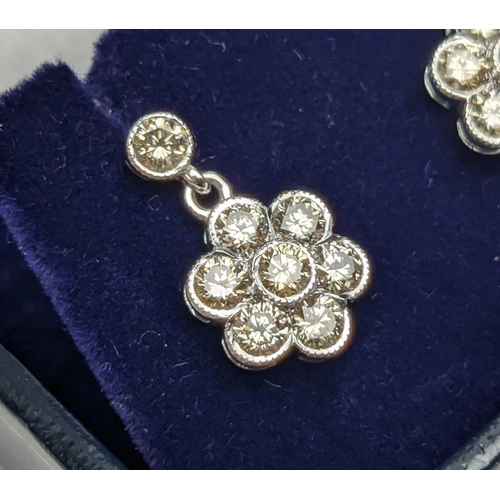 45 - A PAIR OF 18CT WHITE GOLD AND DIAMOND CLUSTER DROPLET EARRINGS, of flower-head design, the diamonds ... 