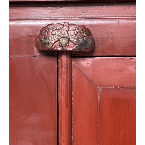 321 - MARRIAGE CABINET, 19th century Chinese scarlet lacquered with two panelled doors enclosing hanging, ... 