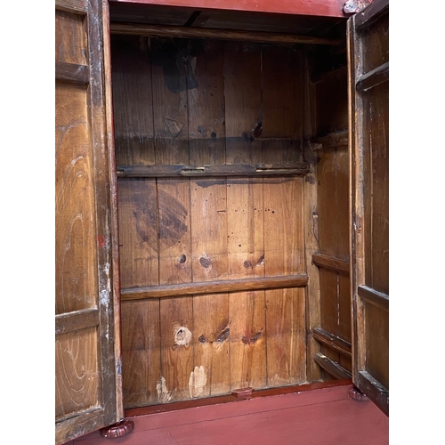 321 - MARRIAGE CABINET, 19th century Chinese scarlet lacquered with two panelled doors enclosing hanging, ... 