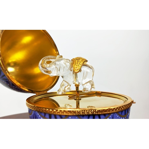 22 - FABERGE EGG, limoges royal blue and gilt porcelain hinged lid opening to reveal musical glass elepha... 