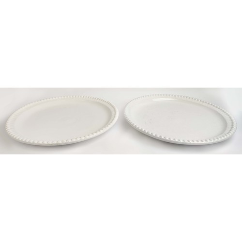 8 - CERAMIC PLATES, a near pair, in a clear glaze, with a beaded  border, 50cm D. (2)